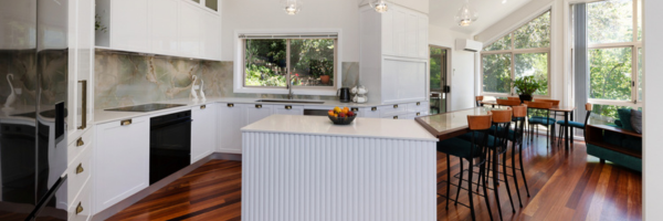 A kitchen with a bar and stoolsAI-generated content may be incorrect.